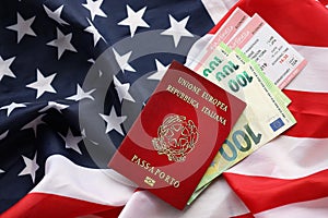Italian passport and money on United States national flag background