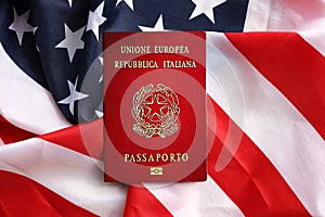 Italian passport on United States national flag background close up. Tourism and diplomacy