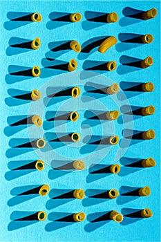 Italian pasta arranged in rows on a blue background