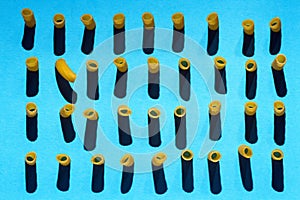 Italian pasta arranged in rows on a blue background