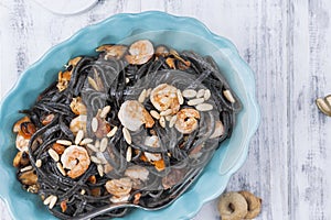 Italian Pasta is black with mussels and shrimps. Parmesan, Seafood, various snacks for dinner. Bright dishes and white background