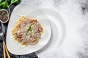 Italian pasta bolognese. Spaghetti with meat and tomato sauce in a plate. Gray background. Top view. Copy space