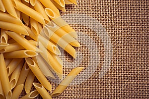 Italian pasta close up and sackcloth background