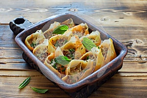 Italian pasta conchiglioni  filling with meat ground and ricotta