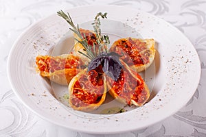 Italian pasta Conchiglioni Rigati. Delicious dish stuffed with ground meat with dry tomatoes in tomato sauce. Closeup on