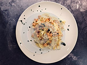 Italian Pasta. Delicious Tagliatelle with salmon and sauce.