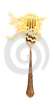 Italian pasta design element. A fork with fusilli, shot from the top