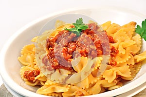 Italian pasta farfalle with meat and tomato sauce
