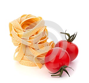 Italian pasta fettuccine nest and cherry tomato