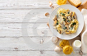 Italian pasta fetuccini with mushrooms, chicken meat, spinach and cream sauce