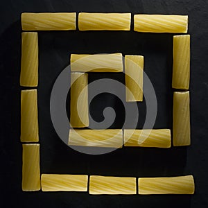 Italian pasta in the form of typical Egyptian, Assyrian and Greek ornaments on a black background