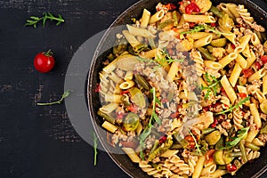 Italian pasta penne and fusilli with minced meat and vegetables.