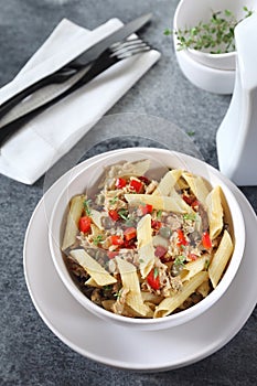 Italian pasta penne salad with tuna, bell pepper and capers
