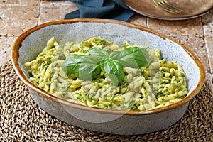 Italian pasta with pesto in ceramic bowl photo