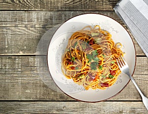 Italian pasta in a plate, tasty and spicy spaghetti. Tomato, parmesan, garlic.