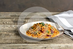 Italian pasta in a plate, tasty and spicy spaghetti. Tomato, parmesan, garlic.