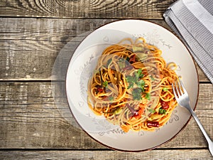 Italian pasta in a plate, tasty and spicy spaghetti. Tomato, parmesan, garlic.