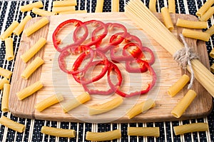 Italian pasta and slices of red bell pepper