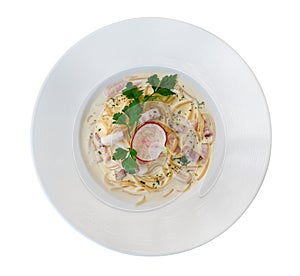 Italian pasta spaghetti carbonara with fried bacon in ceramic plate top view isolated on white background, clipping path