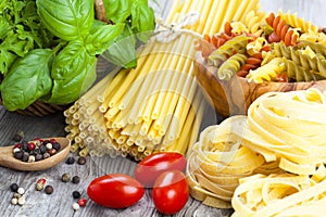 Italian pasta, spaghetti, fettuccine nest with garlic, tomatoes