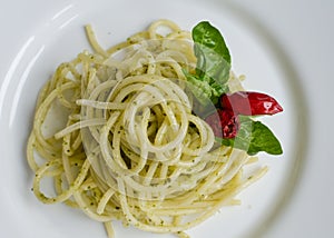 Italian pasta spaghetti with homemade pesto sauce and basil leaf