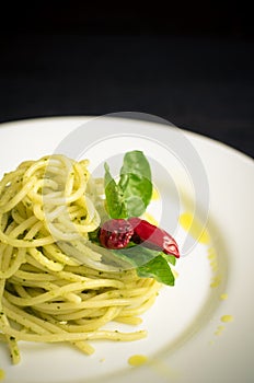 Italian pasta spaghetti with homemade pesto sauce and basil leaf