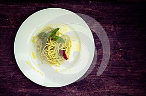 Italian pasta spaghetti with homemade pesto sauce and basil leaf