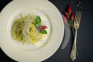 Italian pasta spaghetti with homemade pesto sauce and basil leaf