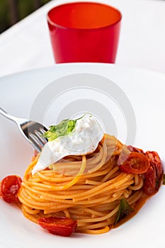 Italian pasta - spaghetti with stracciatella cheese closeup, mediterranean diet