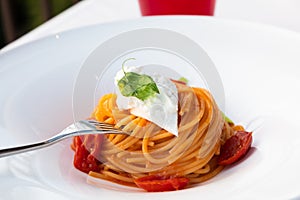 Italian pasta - spaghetti with stracciatella cheese closeup, mediterranean diet