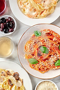 Italian pasta. Spaghetti with tomato sauce and basil, wine, Parmesan cheese