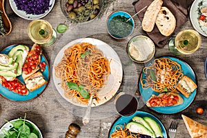 Italian pasta with tomato sauce with snacks and wine