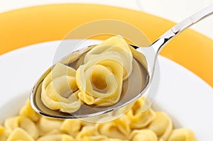 Italian pasta ,tortellini in broth, closeup