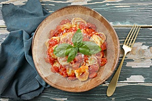 Italian pasta tortellini with tomato sauce and mozzarella cheese