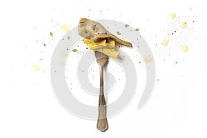 Italian pasta. A vintage fork with penne pasta, an artichoke, thyme leaves, ground pepper, and olive oil, on a white background