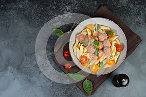 Italian Penne pasta with meatballs, tomatoes and aromatic herbs