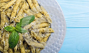 Italian penne pasta with sauce pesto Food background