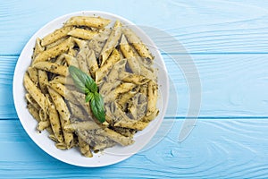 Italian penne pasta with sauce pesto Food background