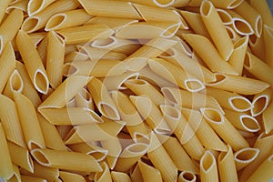Italian Penne Rigate Pasta raw food background photo