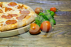 Italian Pepperoni pizza with salami on dark wooden background. Italian traditional food. A textured background. Copy paste place
