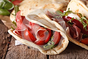 Italian piadina flatbread stuffed with ham and vegetables close-