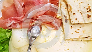 Italian piadina with ham, cheese and lettuce