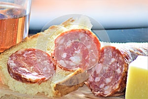 Italian picnic with pork sausage salami cheese bread red wine