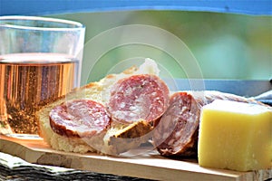 Italian picnic with pork sausage salami cheese bread red wine