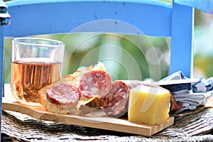 Italian picnic with pork sausage salami cheese bread red wine