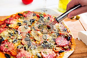 Italian pizza. Delicious italian pizza served on white wooden table. Top view