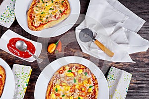 Italian Pizza Restaurant Menu - Margarita and Salmon Pizza. Pizza Dinner. pizzas served on wooden table Top View