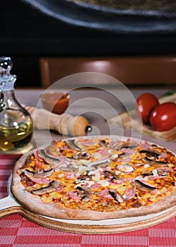 Italian pizza tomato sauce with ham and mushrooms photo