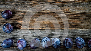 Italian plums on wooden background
