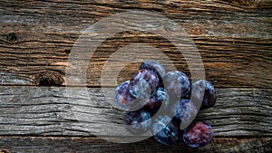 Italian plums on wooden background